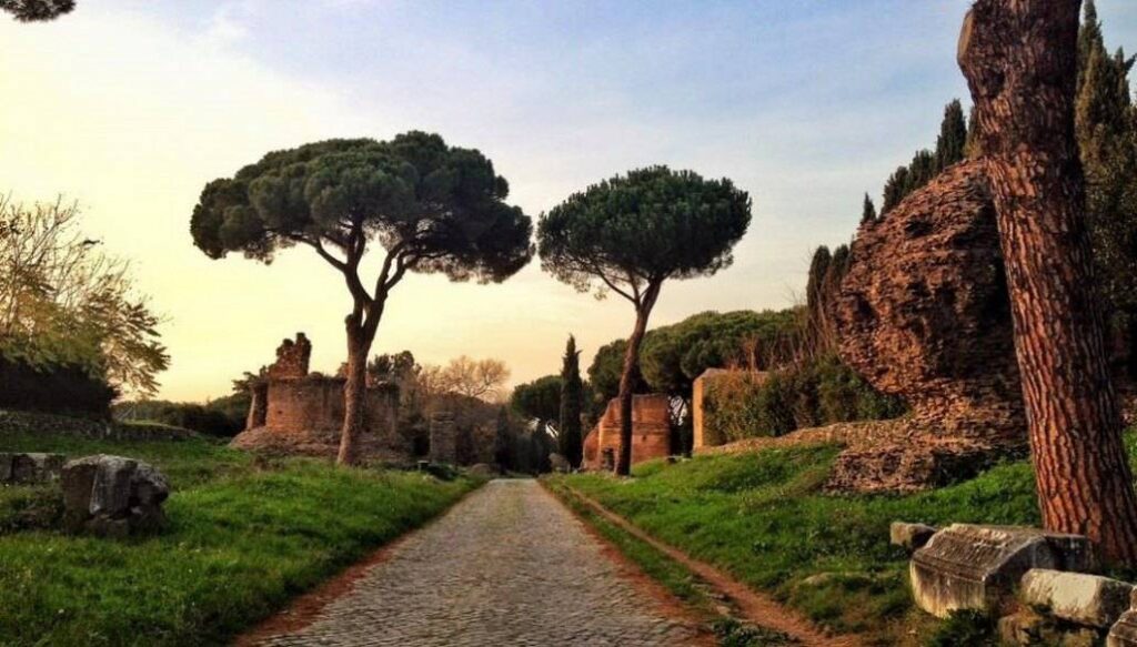 Scenic view of the historic Appian Way, showcasing ancient ruins and picturesque countryside landscapes.